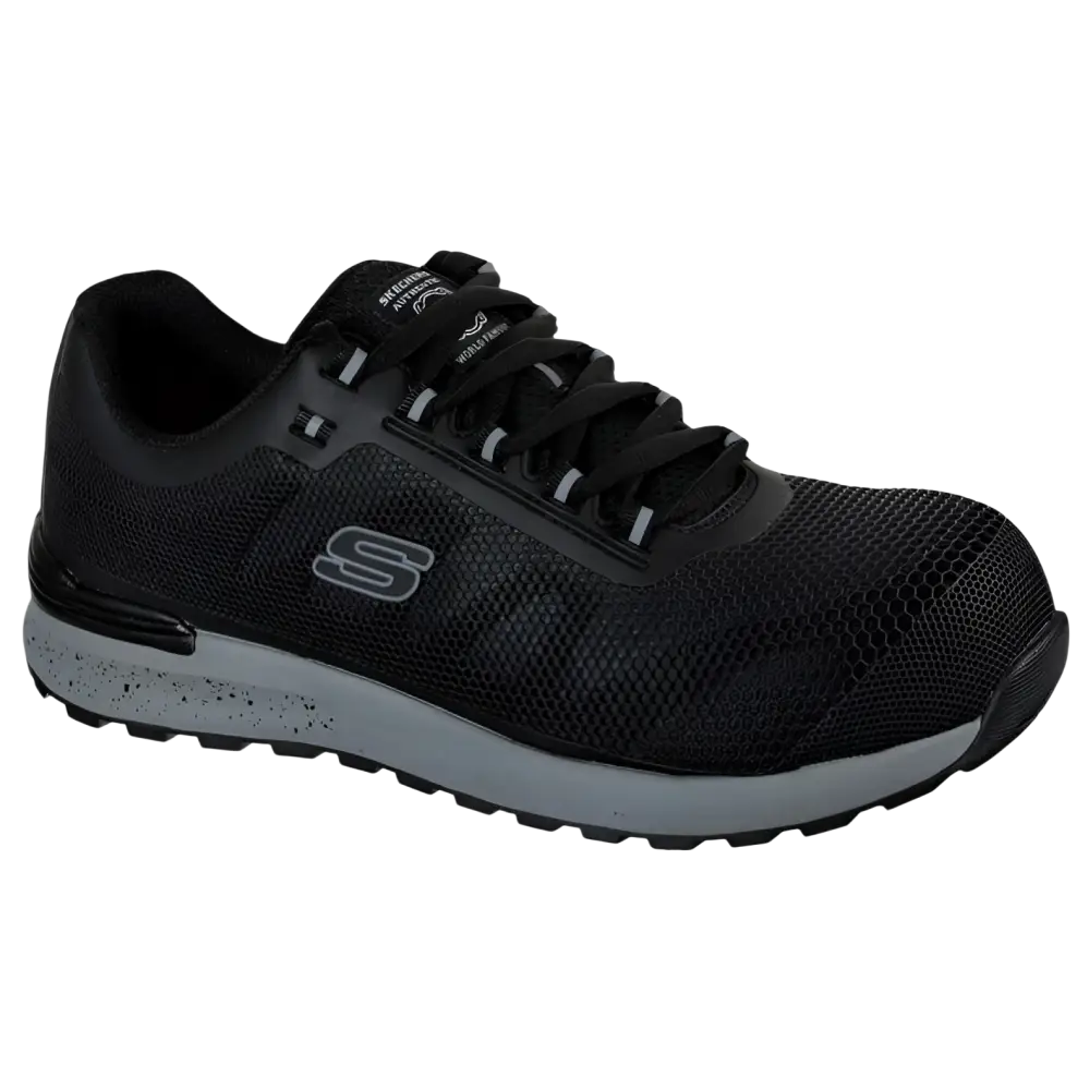 Scarpa atletica Skechers nera con tomaia in mesh, intersuola grigia macchiata di puntini neri e cappuccio rinforzato sulla punta.