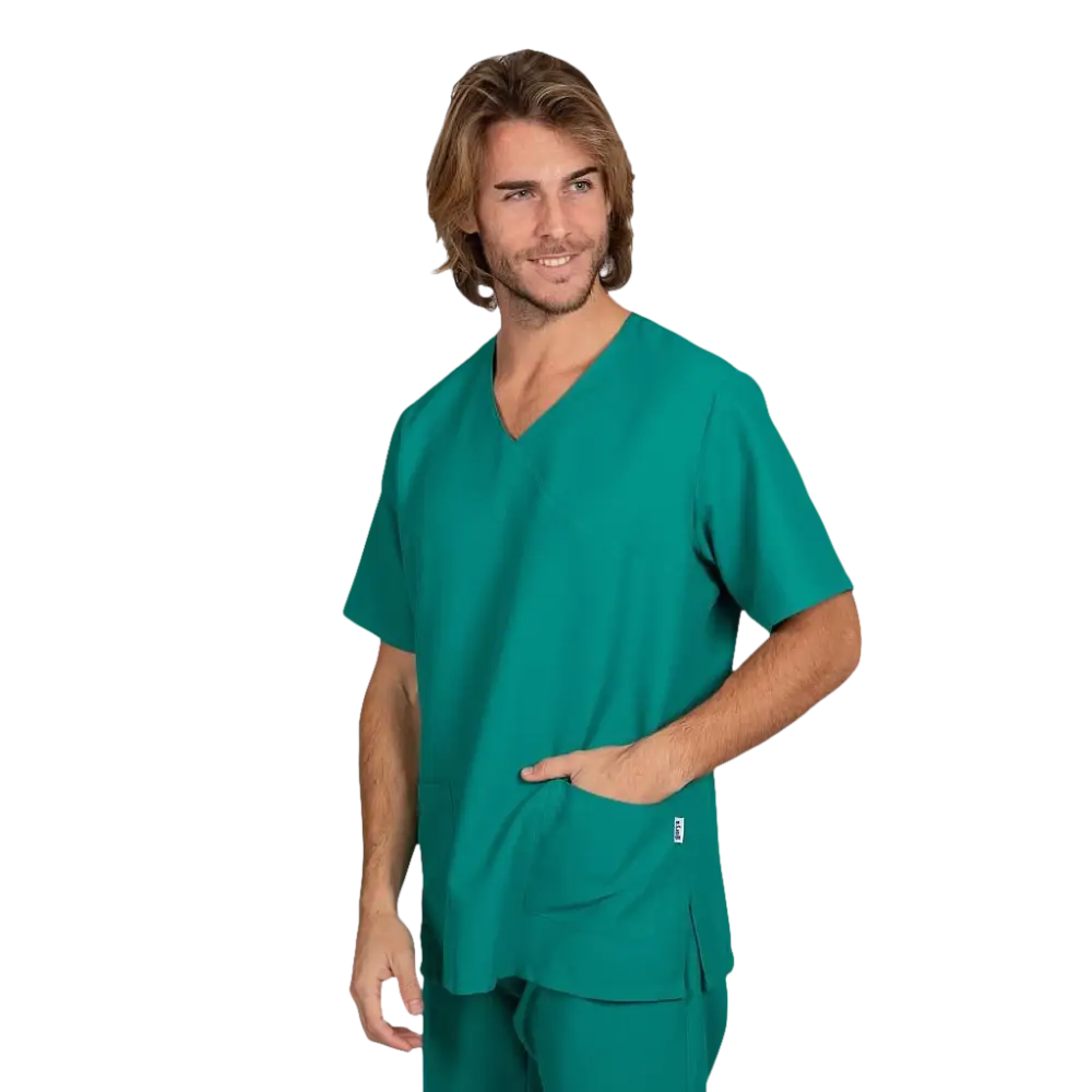 Un modello maschile che indossa un top scrub verde acqua con scollo a V e un’unica tasca frontale e pantaloni abbinati.